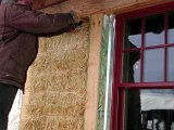 Stuffing bales in corners.jpg